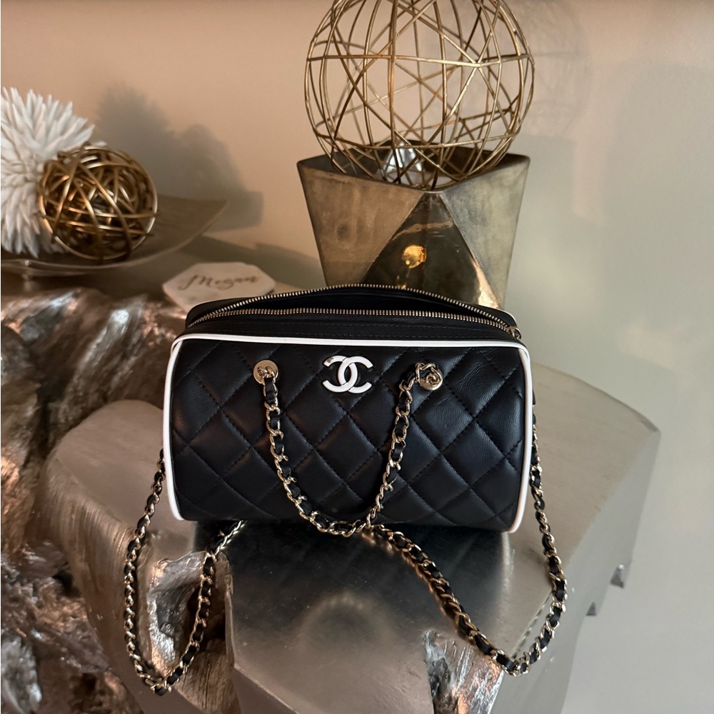CHANEL Black Quilted Shoulder Bag with White Trim and Silver Hardware